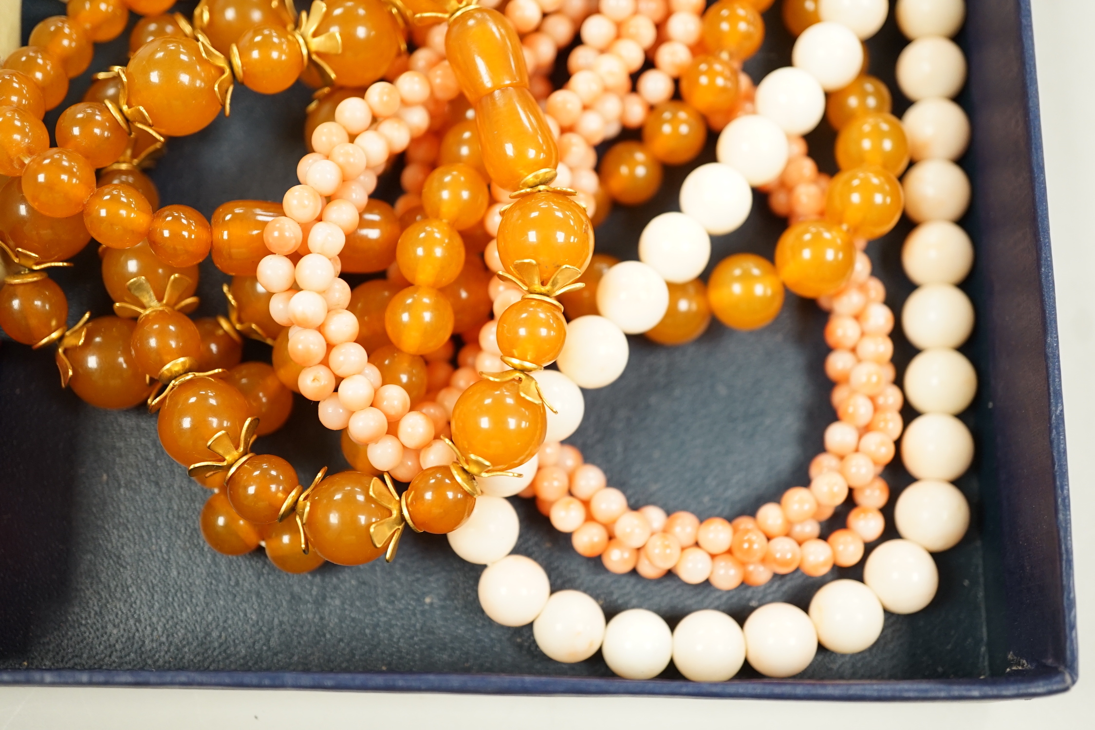 A 9ct and opal doublet ring, two other 9ct and gem set rings, an Edwardian yellow metal and swivelling carnelian ring and six assorted necklaces.